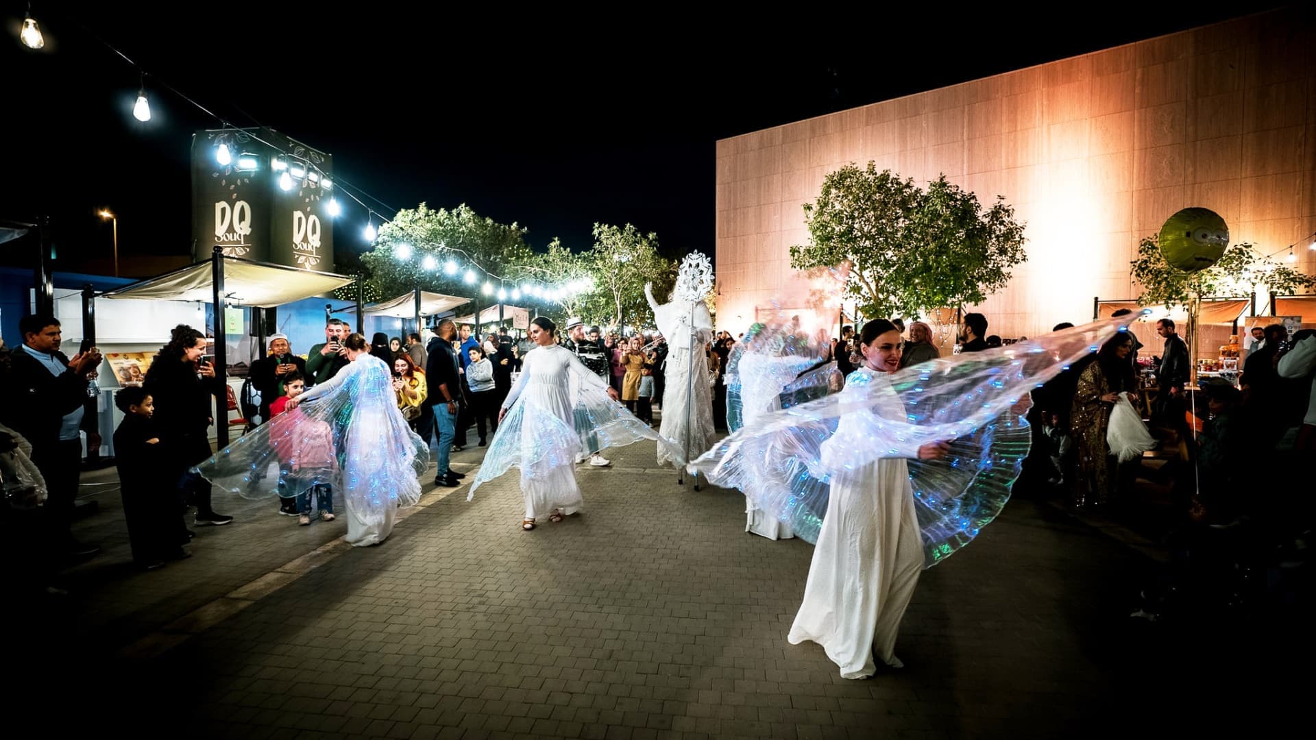 Night performance with illuminated dancers