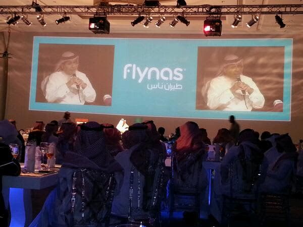 flynas identity launch, aircraft livery graphic, audience and main screen with logo, aircraft on runway